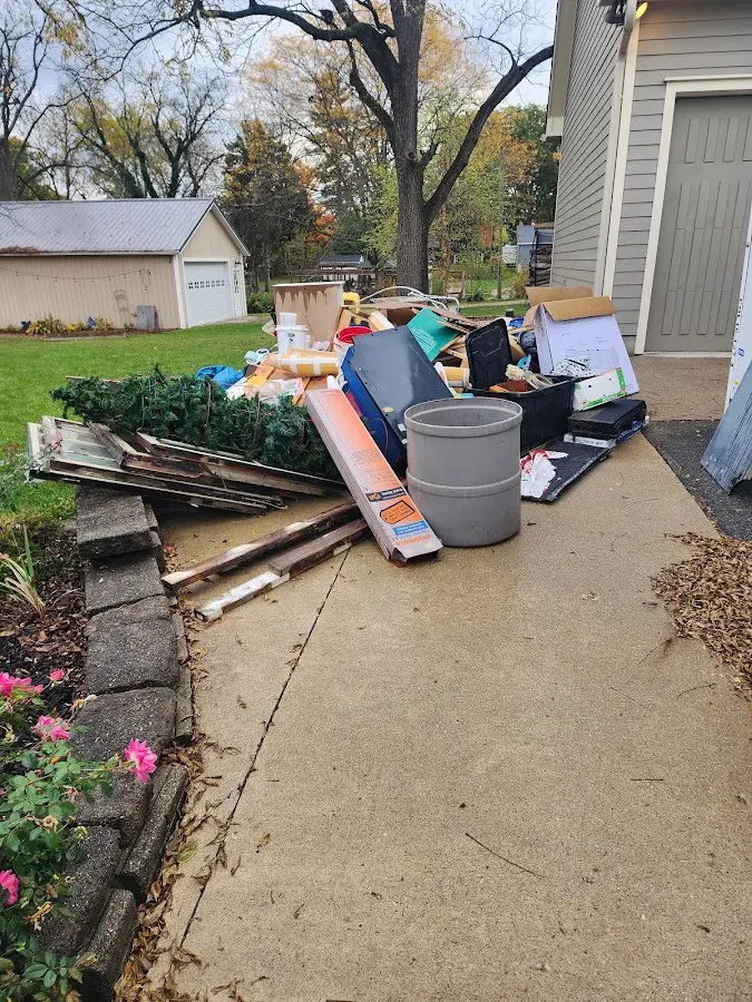 Dumpster being loaded with debris for 3 Yard Dumpster Rental in Wind Lake